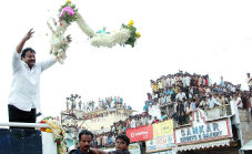Praja Rajyam president Chiranjeevi throws garlands at the cheering crowds in Pulivendula on Wednesday.