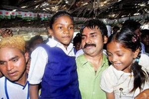 The Yuvarajyam Chief Pavan Kalyan talking to two ashram schoolgirls at Nimmalagudem in Bhadrachalam division 